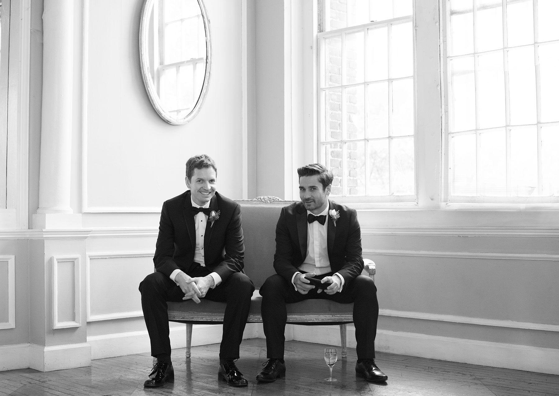 2 young grooms sitting in Reception hall of Brooklyn Wedding