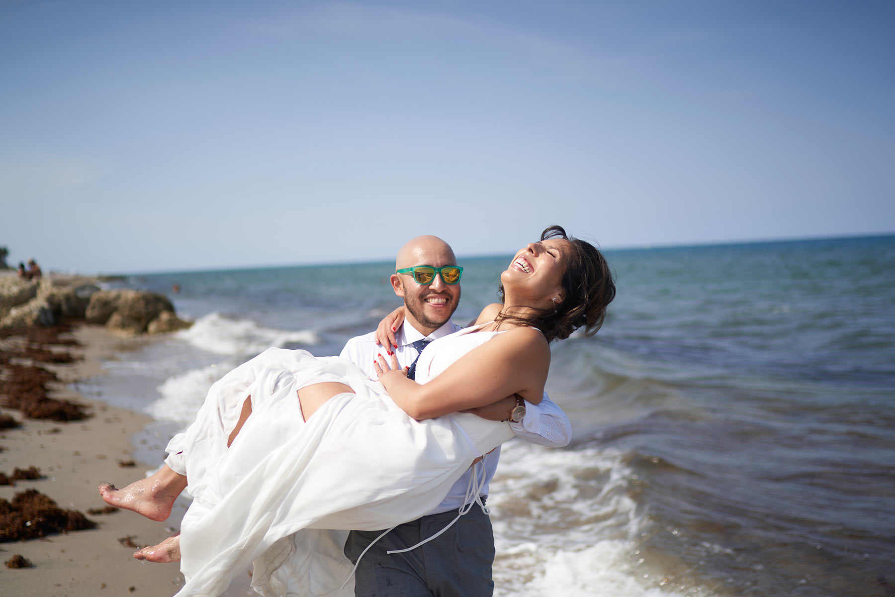 Groom-holding-his-new-Bride-in-hois-arms-at-Palm-Beach-beach